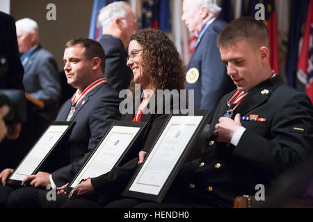 Troy Yocum, Sharon Landsberry and Connor Stotts pose for photographs during the Citizen Honors Ceremony at the Women in Military Service for America Memorial March 25, 2014, in Arlington, Va. Yocum and Stotts received Citizen Service Before Self medals. Landsberry received the medal for her late husband Michael. Heroism defined on MoH Day at Arlington 140325-A-DQ287-876 Stock Photo