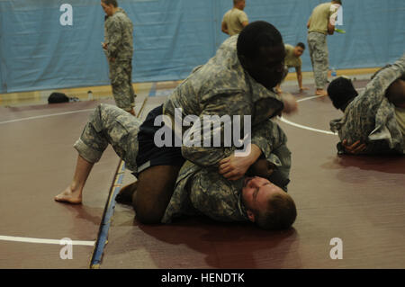 Pfc. Michael Gales (top), from Atlanta, Ga., a motor transport operator assigned to 579th Forward Support Company, 6th Battalion, 37th Field Artillery Battalion, 210th Field Artillery Brigade, gains top control against his opponent during a training session March 31, 2014, at Carey Fitness Center on Camp Casey, South Korea. (U.S. Army photo by Sara E. Wiseman, 210th Field Artillery Brigade Public Affairs/Released) Soldier overcomes obstacles in pursuit of greatness 140331-A-DF794-024 Stock Photo