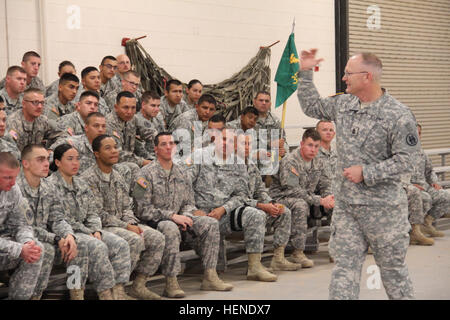 Command Sgt. Maj. Paul E. Shaw, senior enlisted adviser for the 324th Military Police Battalion, gives a brief welcome home brief to Soldiers assigned to 357th Military Police Company after arriving at the Arrival/Departure and Air Control Group, April 2, from Guantanamo Bay, Cuba.  (Photo by Amabilia Payen, DoMaD) 357th MP Co. returns from Gitmo 040214-A-DO208-003 Stock Photo