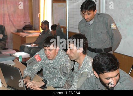 U.S. Army Sgt. 1st Class Eric R. Lasica, left, a joint regional coordination center mentor with 508th Special Troops Battalion, 4th Brigade Combat Team, 82nd Airborne Division, assists Afghan National Police 2nd Sgt. Farhad Sidiqi with a map-reading program in Ghazni Province, Afghanistan, March 4, 2008. Sidiqi is the battle noncommissioned officer for the joint regional coordination center.  (U.S. Army photo by Spc. Nathan W. Hutchison) (Released) US soldier with Afghan National Police in Ghazni province Stock Photo