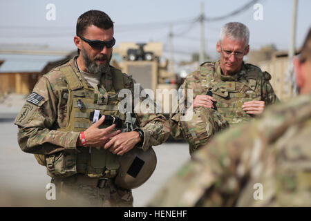 U.S. Army Capt. Walter Frye, a chaplain assigned to Special Operations Task Force-South, says a prayer before a humanitarian aid mission to local children at a school in Kandahar district, Kandahar province, Afghanistan, April 16, 2014. The mission was conducted in order to provide for families in need of assistance, and to deepen a cultural understanding between the ANA and the local populace, thus creating a more maneuverable environment for U.S. and Afghan service members.  (U.S. Army photo by Spc. Sara Wakai/Not Released) Humanitarian aid 140416-A-YF193-014 Stock Photo