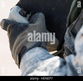 A U.S. Army Soldier, assigned to 977th Military Police Company, 97th Military Police Battalion, 1st Infantry Division, controls an AeroVironment RQ-11 Raven during a training operation at the National Training Center, April 19, 2014. The Raven is a small hand-launched remote-controlled unmanned aerial vehicle (UAV) used to show higher command a bird's eye view of a specific terrain. (U.S. Army photo by Sgt. Richard W. Jones Jr., Operations Group, National Training Center) National Training Center RQ-11 Raven exercise 140419-A-QU939-789 Stock Photo