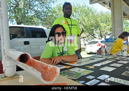 Sandylane Oquendo, the Operation Liquid Gold executive director from Central Texas College's branch of ENACTUS, sits behind the display for a program designed to help dispose of used cooking oil at Fort Hood's Earth Day celebration, April 25. ENACTUS, a volunteer organization, partnered with CENTEX Grease Recovery to help Killeen and Harker Heights residents dispose of their used cooking oil. Fort Hood Earth Day 2014 140425-A-OB963-033 Stock Photo