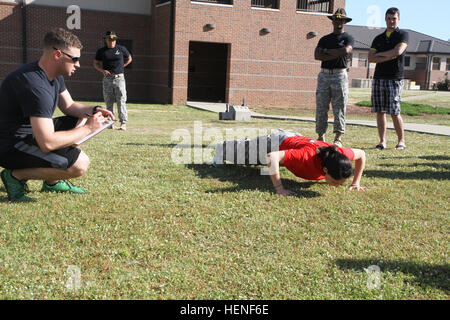 Nearly 30 spouses from 3rd Squadron, 1st Cavalry Regiment, 3rd Armored Brigade Combat Team, 3rd Infantry Division, reported for duty, April 26, at Sledgehammer Field. The women formed up and marched to various lanes throughout Kelley Hill, where they had to fire weapons during a simulated range, don a pro-mask during a chemical attack, provide aid to a casualty while preparing him for a medical evacuation, react to contact while calling for fire, and answer cavalry-related questions during a Spur Board. Blackhawk spouses earn spurs 140426-A-IP604-631 Stock Photo