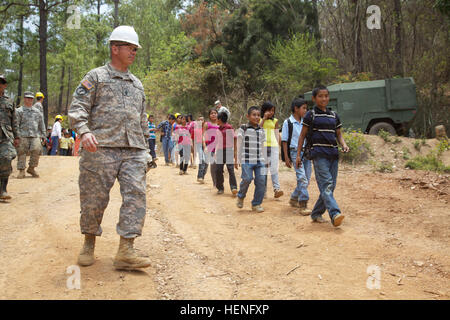 U.S. Army Engineers lead Guatemalan children on a tour of a new school in Chiquimula, Guatemala, as part of Beyond the Horizon 2014, providing humanitarian and educational support. Stock Photo