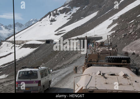 Vehicles from the 114th Transportation Company and 730th Transportation Company convoy escort team prepare to enter several tunnels located at the Salang Pass in Afghanistan during a mission in support of Operation Enduring Freedom. The CET provides security for National Afghan Trucking vehicles to ensure the loads arrive to the destination safely. Entering a tunnel at the Salang Pass 140512-A-VH456-030 Stock Photo