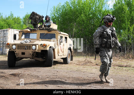 Soldiers of the 3rd Squadron, 1st Cavalry Regiment, 3rd Infantry Division out of Fort Benning, Ga., depart base camp during operations as the opposition force during Exercise Maple Resolve 2014 (EX MR14). Approximately 5,000 Canadian, British and U.S. troops participated in EX MR14, conducted here May 5-June 1. It is the culminating collective training event that validates the Canadian Army's High Readiness force for operations assigned to it by the Canadian government through the Chief of Defense Staff. 3rd ID troops augment OPFOR at Maple Resolve 14 140523-A-LG811-019 Stock Photo