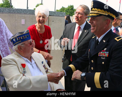 Senior Virginia and Maryland National Guard leaders and Soldiers from the 116th Infantry Brigade Combat Team pay tribute to the valor, fidelity and sacrifice of D-Day participants at the observance of the 70th anniversary of the Allied invasion of Normandy June 6, 2014, at the National D-Day Memorial in Bedford, Va. Brig. Gen. Timothy P. Williams, the Adjutant General of Virginia, and Brig. Gen. Blake C. Ortner, the Virginia National Guard Land Component Commander, read historical vignettes during the ceremony, and Brig. Gen. Timothy E. Gowen, Deputy 29th Infantry Division Commander  - Marylan Stock Photo