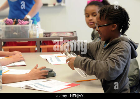 A young girl pumps a bottle full of air while participating in a class at the Peach State STARBASE summer camp at Dobbins Air Reserve Base June 9, 2014. The class taught children about air pressure as part of the science, technology and engineering based curriculum of the camp. (Georgia Army Guard photo by Spc. Steven Bennett) Peach State STARBASE 140609-A-HF852-398 Stock Photo