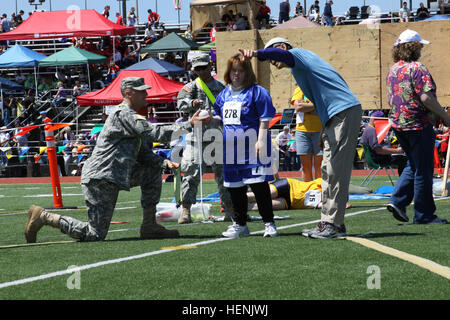 Soldiers from 61st Chemical Company, 23rd Chemical Battalion, assist athletes in the softball throw events of the Washington Special Olympics on June 5, 2010, at Joint Base Lewis - McChord. The year 2010 marks the first year that Fort Lewis and McChord Air Force Base host the Special Olympics as a joint installation. Washington Special Olympics 286819 Stock Photo