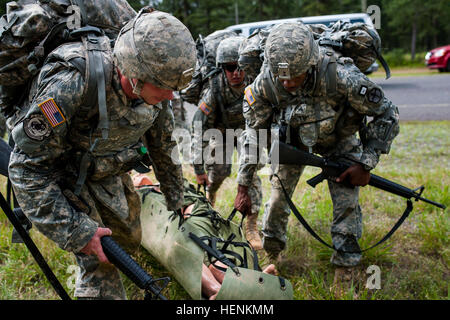 Soldiers carry a 165-pound dummy one mile to an M16 rifle qualification ...