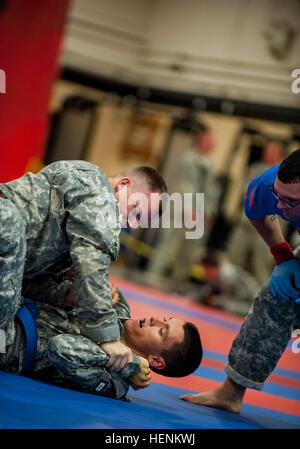 Staff Sgt. Landon Nordby, of St. James, Minn., grapples on top of Staff Sgt. Steven Alvarez, of Boonville, Calif., in the Modern Army Combatives tournament during the 2014 Army Reserve Best Warrior Competition at Joint Base McGuire-Dix-Lakehurst, N.J., June 26. Nordby represents the 200th Military Police Command and Alvarez represents the 84th Training Command. (U.S. Army photo by Sgt. 1st Class Michel Sauret) Army Reserve warriors go head-to-head in Modern Army Combatives tournament 140626-A-TI382-313 Stock Photo
