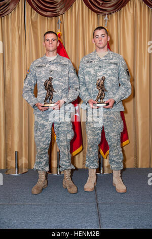 U.S. Army Staff Sgt. Landon Nordby, left, with the 200th Military Police Command, the winner of the noncommissioned officer category and Spc. Keegan Carlson, with the U.S. Army Civil Affairs Psychological Operations Command, winner of the junior enlisted category, stand with their trophies during the awards ceremony of the 2014 Army Reserve Best Warrior Competition at Joint Base McGuire-Dix-Lakehurst, N.J., June 27, 2014.  (U.S. Army photo by Sgt. 1st Class Michel Sauret/Released) U.S. Army Staff Sgt. Landon Nordby, left, with the 200th Military Police Command, the winner of the noncommissione Stock Photo