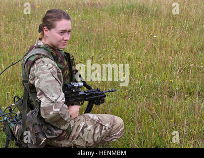 British Army Royal Military Academy Sandhurst cadet Jessica Glover waits for further instruction after calibrating her weapon. Sandhurst and West Point Military Academy cadets completed their second day of a joint two-week field exercise with live-fire training. The exercise consisted of individual and squad movements on range 204 at the Grafenwoehr Training Area at the U.S. Army's 7th Army Joint Multinational Training Command, July 8. Cadets from Sandhurst are completing their final field exercise and the 50 West Point cadets are completing their leadership development training in an exercise Stock Photo