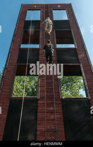 Fire and Rescue Chief Capt. Andrzej Podolak (center), of Drawsko Pomorskie, Poland, accompanies Pfc. Justin Battles, a native Baytown, Texas, and a paratrooper assigned to 2nd Battalion, 503rd Infantry Regiment, 173rd Airborne Brigade, during a rappelling exercise July 15, 2014. Operation Atlantic Resolve is a U.S. and NATO effort to build stronger local and international relationships with European allies and demonstrates the solidarity with between the United States and Poland through training. (U.S. Army Photo by Spc. Hector Rene Membreno-Canales/Released) Local Polish firefighters train pa Stock Photo