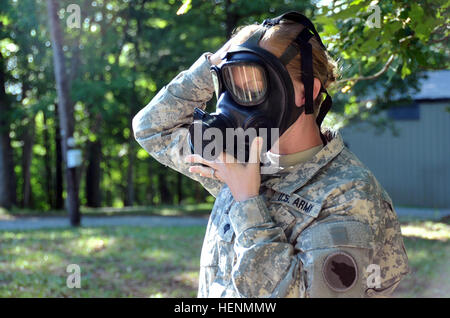 U.S. Army Spc. Katie Ray, platoon trainer, Chemical Biological Radiological Nuclear lane, Task Force Wolf, demonstrates the proper technique to don the gas mask during Cadet Summer Training (CST) on Fort Knox, Ky., July 15. The CBRN cadre, comprised of Reserve Soldiers from 2nd Battalion, 319th Regiment, 3rd Brigade, 104th Training Division, introduce cadets to the basics of CBRN. They teach them about all components of the protective gear and the proper procedures in reacting to a threat. (U.S. Army photo by Staff Sgt. Shejal Pulivarti/released) Cadre challenge cadets in chemical environment 