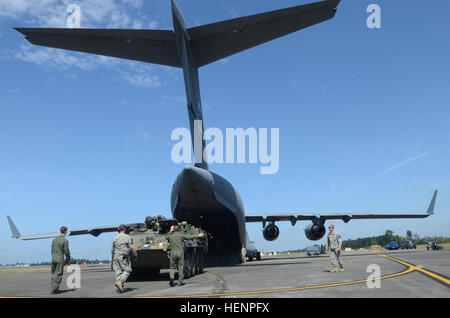 In this photo from August 2015, 3-2 Stryker Brigade Combat Team Soldiers and airmen from the 62nd Airlift Wing load a Stryker combat vehicle onto a C-17 aircraft during training at Joint Base Lewis-McChord, Wash. Soldiers from 2nd Battalion, 3rd Infantry Regiment, 3-2 SBCT, recently took part in training like this which involved preparing gear, checking equipment and departing by plane in a quick fashion to simulate a rapid deployment. Arrowhead Soldiers train for quick departures 140822-A-WG307-001 Stock Photo