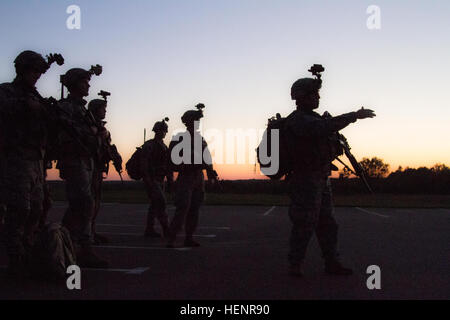 Sgt. 1st Class Joshua Gerry (right), a Dickson, Tenn. native, and platoon sergeant assigned to Company D, 2nd Battalion, 503rd Infantry Regiment, 173rd Airborne Brigade, shows the members of Company D where the UH-60 Black Hawk helicopters will land before they conduct a night raid in support of Exercise Steadfast Javelin II near Drawsko Pomorskie, Poland, Sept. 3, 2014.  Company D conducted an air assault mission at night to destroy a radar site and to gather intelligence for other units to use throughout the exercise. Steadfast Javelin II is a NATO exercise involving over 2,000 troops from 1 Stock Photo