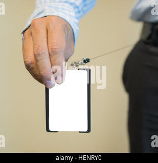 Close up of businessperson hands holding security keycard to open secure door Stock Photo