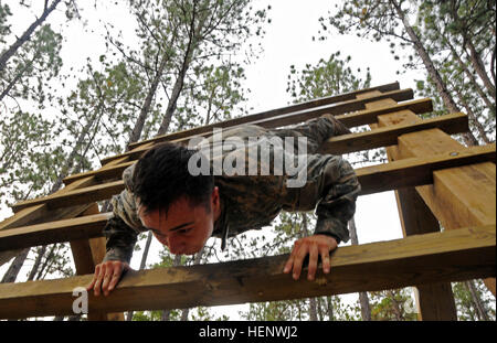 Spc. Beau Pratt, a medic assigned to the 82nd Airborne Division, navigates the obstacle course at the Division’s Pre-Ranger Course Oct. 7, on Fort Bragg, N.C. The obstacle course was part of the All American Best Medic Competition. The competition puts the medics’ tactical and technical proficiency to the test with Combat Testing Lanes and land navigation among other things. The winning team will go on to compete in the Army-wide competition next month at Fort Sam Houston, Texas. (Sgt. 1st Class Joseph Armas/82nd Airborne Division) All American Best Medic Competition 141007-A-PX133-004 Stock Photo