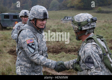 U.S. Army Maj. Gen. Michael A. Bills, commanding general of 1st Cavalry Division, shakes hands with Capt. Stephen Truesdale of Assault Company, 2nd Battalion, 12th Cavalry Regiment, 1st Brigade Combat Team, 1st Cavalry Division during exercise Combined Resolve III at the Joint Multinational Readiness Center in Hohenfels, Germany, Oct. 28, 2014.  Combined Resolve III is a multinational exercise, which includes more than 4,000 participants from NATO and partner nations, and is designed to provide a complex training scenario that focuses on multinational unified land operations and reinforces the Stock Photo