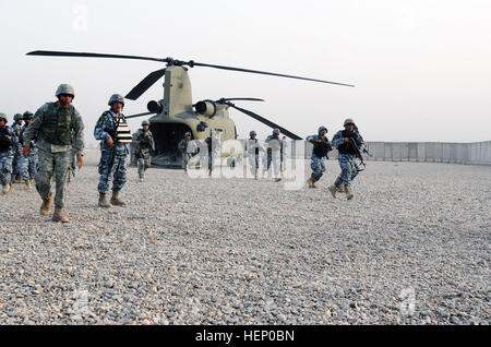 Paratroopers assigned to K Troop, 5th Squadron, 73rd Cavalry, 82nd Airborne Division, Multi-National Division - Baghdad and national police officers assigned to the 3rd NP Brigade, 1st NP Division rehearse the proper way to exit a CH-47 Chinook helicopter prior to conducting an air assault clearance operation, June 26, on Forward Operating Base Hammer, Iraq. The combined forces partnered during an Iraqi-led operation dubbed 'Operation Winged Lion II.' The operation was in order to assess security in the Ma'dain region, located outside of eastern Baghdad. Iraqis lead air assault 183086 Stock Photo