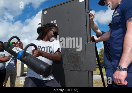 A Junior Reserve Officer Training Corps cadet from South Dade High School tries to breach a door open while working with a U.S. Coast Guard Maritime Safety Security Team member Jan. 22 during a two-day mentorship event as part of Special Operations Command South’s Military Assistance Program on Homestead Air Reserve Base, Fla. More than 180 cadets from Homestead High and South Dade High Schools participated in the event where the cadets got to see a local police dog demonstration, they interacted with members of the base’s explosive ordnance disposal (EOD) team and their equipment, and they ob Stock Photo