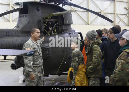 Sgt. Juan Aguilar, OH-58D helicopter repairer, Alpha Troop, 1st Squadron, 17th Cavalry Regiment, 82nd Combat Aviation Brigade, explains the capabilities of the OH-58D Kiowa to the Cameron Boys Camp from Cameron, N.C., during a visit to Fort Bragg, N.C., Jan. 23. The Cameron Boys Camp provides the boys a residential program for an opportunity to work out problems through an alternative education program. (U.S. Army photo by Capt. Adan Cazarez/82nd Combat Aviation Brigade PAO) 1st Squadron, 17th Cavalry Regiment, 82nd Combat Aviation Brigade, hosted the Cameron Boys Camp from Cameron, NC 140921- Stock Photo