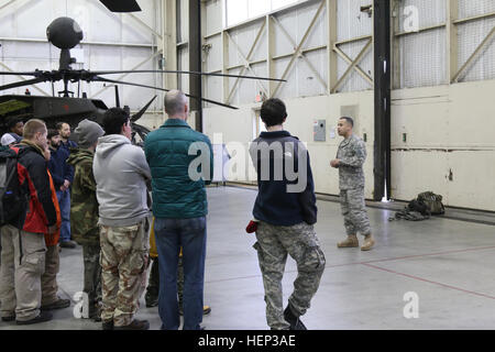 Chief Warrant Officer 2 Frank Caputo, OH-58D helicopter pilot, Alpha Troop, 1st Squadron, 17th Cavalry Regiment, 82nd Combat Aviation Brigade, speaks to a group of boys who belong to the Cameron Boys Camp from Cameron, N.C, during a visit to Fort Bragg, N.C., Jan. 23. The Cameron Boys Camp provides the boys a residential program for an opportunity to work out problems through an alternative education program. (U.S. Army photo by Capt. Adan Cazarez/82nd Combat Aviation Brigade PAO) 1st Squadron, 17th Cavalry Regiment, 82nd Combat Aviation Brigade, hosted the Cameron Boys Camp from Cameron, NC 1 Stock Photo