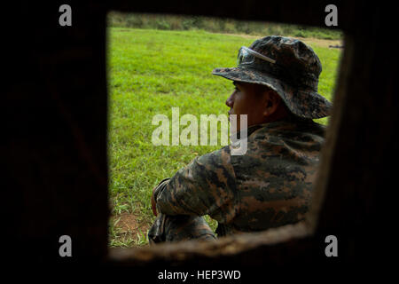 A Guatemalan special forces soldier, or 'Kaibil,' with the “Grupo Especial de Interdicción y Rescate,” awaits instruction from his leaders during a pistol marksmanship training event Jan. 28 in Poptun, Guatemala. The Kaibils are assigned to the 'Grupo Especial de Interdicción y Rescate,” or GEIR, a quick reaction force that specializes in interdiction and rescue operations throughout the country. Special Operations Command South assists partner nations through training exchanges enabled by its theater security cooperation program. Kaibil, US special forces promote security through partnership  Stock Photo