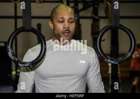 Sgt. 1st Class Bryan Vann, the NCO in charge of the communications section of the 2nd Combat Aviation Brigade, 2nd Infantry Division, prepares to exercise using the rings Jan. 28 at the fitness annex on Camp Humphreys, South Korea. Raising the bar 012815-A-TU438-002 Stock Photo