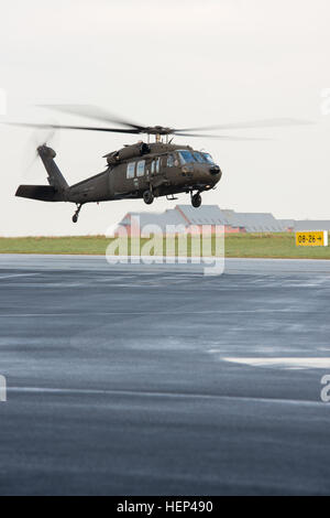 A UH-60A Black Hawk helicopter with the Supreme Headquarters Allied Powers in Europe Helicopter Flight Detachment lands after a logistical mission flight, on Chièvres Air Base, Chièvres, Belgium, Feb. 5, 2015. (U.S. Army photo by Visual Information Specialist Pierre-Etienne Courtejoie/Released) UH-60A Black Hawk helicopter landing, refueling and hauling 150205-A-BD610-237 Stock Photo