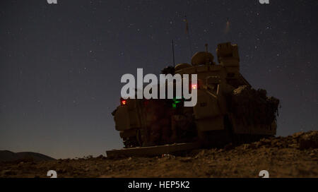 U.S. Soldiers, assigned to Bravo Company, 1st Squadron, 9th Cavalry Regiment, 2nd Brigade Combat Team, 1st Cavalry Division, dismount an M1 Abrams Tank outside an enemy compound during Decisive Action Rotation 15-05 at the National Training Center, Fort Irwin, Calif., Feb. 25, 2015. The rotation ensures brigades remain versatile, responsive and consistently available for the current fight and unforeseen future contingencies. (U.S. Army photo by Sgt. Richard W. Jones Jr./Released) Soldiers breach an enemy compound 150225-A-QU939-155 Stock Photo