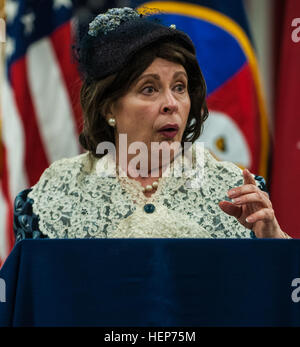 Kate Campbell Stevenson performs as Eleanor Roosevelt during her one-woman show, 'Women: Back to the Future' at the U.S. Army Forces Command and U.S. Army Reserve Command headquarters at Fort Bragg, N.C., March 17, 2015. Portraying Bessie Coleman, Louis Arner Boyd and Roosevelt, Stevenson dressed in period clothing and shared the women's stories in song and monologues to show how they overcame gender-based and societal obstacles to achieve personal and historical success. “Women’s stories have been there all along, we just have to be willing to dig to find them,” said Stevenson. “I present the Stock Photo