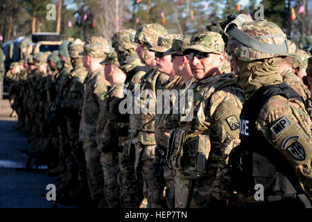 Motor Transport Operator, Sgt. Jose Saquicili from La Troncal, Ecuador, stands with Soldiers from Lightning Troop, 3-2 Cavalry Regiment and the 18th Military Police Brigade before their convoy begins. Saquicili and the Soldiers are participating in Operation Dragoon Ride, where the 2nd Cavalry Regiment marches with Stryker armored vehicles from the Baltic states and Poland to Rose Barracks, Germany. (U.S. Army photo by 1st Lt. Henry Chan, 16th Sustainment Brigade public affairs, 21st Theater Sustainment Command) Dragoon Ride 150322-A-WZ553-336 Stock Photo