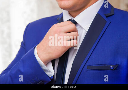 Elegant young fashion man wearing black jacket of formal suit Stock Photo