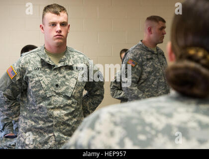 Spc. Michael Goff, 23, a Military Police Soldier, listens to instructions during an inventory of his packing list during day one of the 200th Military Police Command’s Best Warrior Competition on March 31 at Joint Base McGuire-Dix-Lakehurst, N.J. Eight warfighters are competing in the week-long competition held March 31-April 3 in a variety of physical and mental events to earn the top spot of Best Warrior for Soldier and noncommissioned officer of the year. Goff is assigned to the 366th MP Company and from Dallas, Texas. The winners will compete at the Army Reserve Best Warrior Competition he Stock Photo