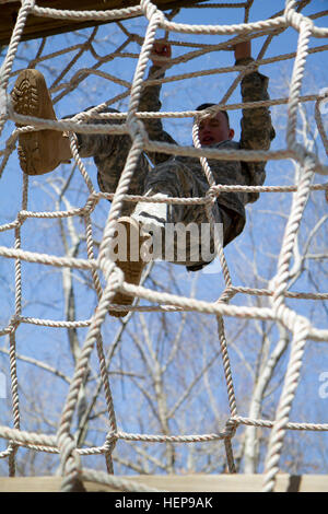 Army Reserve Spc. Michael Goff, 23, a Military Police Soldier, completes an obstacle course event during day two of the 200th Military Police Command’s Best Warrior Competition on April 1 at Joint Base McGuire-Dix–Lakehurst, N.J. Eight warfighters are competing in the weeklong competition held March 31 – April 3 in a variety of physical and mental events to earn the top spot of Best Warrior for Soldier and noncommissioned officer of the year. Goff is assigned to the 366th MP Company and from Dallas. The winners will compete at the Army Reserve Best Warrior Competition held in May. The 200th MP Stock Photo