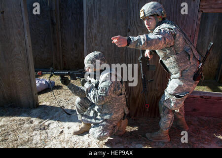 Army Reserve Spc. Michael Goff, 23, a Military Police Soldier, works his way through a scenario-based Army Warrior Task exercise during day two of the 200th Military Police Command’s Best Warrior Competition on April 2 at Joint Base McGuire-Dix-Lakehurst, N.J. Eight warfighters are competing in the week-long competition held March 31-April 3 in a variety of physical and mental events to earn the top spot of Best Warrior for Soldier and noncommissioned officer of the year. Goff is assigned to the 366th MP Company and from Dallas, Texas. The winners will compete at the Army Reserve Best Warrior  Stock Photo