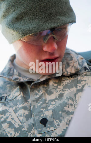 Army Reserve Spc. Michael Goff, 23, a Military Police Soldier, plots his distance points at the daytime navigation course during day two of the 200th Military Police Command’s Best Warrior Competition on April 1 at Joint Base McGuire-Dix-Lakehurst, N.J. Eight warfighters are competing in the weeklong competition held March 31 – April 3 in a variety of physical and mental events to earn the top spot of Best Warrior for Soldier and noncommissioned officer of the year. Goff is assigned to the 366th MP Company and from Dallas. The winners will compete at the Army Reserve Best Warrior Competition h Stock Photo