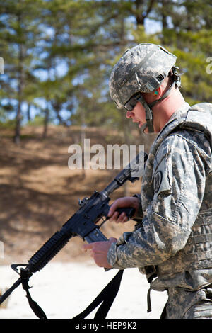 Army Reserve Spc. Michael Goff, 23, a Military Police Soldier, prepares to load his M4 carbine weapon during a reflexive fire exercise during day three of the 200th Military Police Command’s Best Warrior Competition on April 2 at Joint Base McGuire-Dix-Lakehurst, N.J. Eight warfighters are competing in the weeklong competition held March 31 – April 3 in a variety of physical and mental events to earn the top spot of Best Warrior for Soldier and noncommissioned officer of the year. Goff is assigned to the 366th MP Company and from Dallas. The winners will compete at the Army Reserve Best Warrio Stock Photo