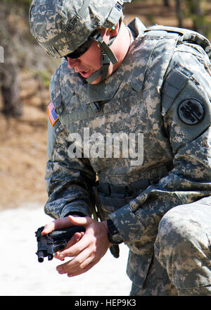 Army Reserve Spc. Michael Goff, 23, a Military Police Soldier, loads his M9 weapon during a reflexive fire exercise during day three of the 200th Military Police Command’s Best Warrior Competition on April 2 at Joint Base McGuire-Dix-Lakehurst, N.J. Eight warfighters are competing in the weeklong competition held March 31 – April 3 in a variety of physical and mental events to earn the top spot of Best Warrior for Soldier and noncommissioned officer of the year. Goff is assigned to the 366th MP Company and from Dallas. The winners will compete at the Army Reserve Best Warrior Competition held  Stock Photo