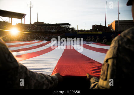 Soldiers 11th Air Defense Artillery Brigade, unfurl a field size flag during the El Paso Chihuahuas opening night, at El Paso, Texas, April 9, 2015. More than 50 Soldiers from across Fort Bliss, Texas supported the opening day for the El Paso Chihuahuas, a AAA baseball affiliate for the Sand Diego Padres. (U.S. Army photo by: Sgt. Marcus Fichtl, 24th Press Camp) El Paso Chihuahuas opening night 150409-A-TW035-690 Stock Photo