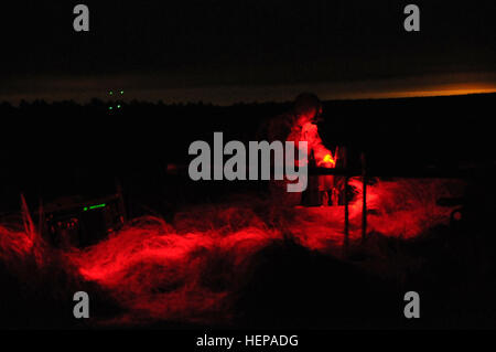 M119a3 crews with 2nd Battalion, 319th Airborne Field Artillery Regiment, 82nd Airborne Division Artillery, work through the dark of night after a mass tactical airborne operations to get the Howitzer laid and in action providing indirect fires for the ground troops on the drop zone. (Capt. Joe Bush, 82nd Airborne DIVARTY/ Released) CJOAX night 150417-A-BG594-002 Stock Photo