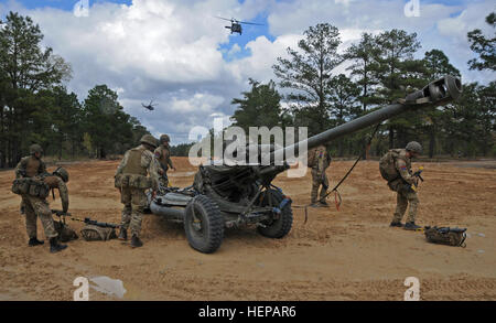 UH 60s sling load two British L118 light guns dropping them and the crews with 7th Royal Horse Artillery and 2nd Battalion, 319th Airborne Field Artillery Regiment down in support of operations during the Combined Joint Operational Access Exercise here on Fort Bragg, N.C. (Capt. Joe Bush, 82nd Airborne DIVARTY/Released) CJOAX Fires 150417-A-BG594-036 Stock Photo