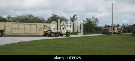 Terminal High Altitude Area Defense equipment from Battery D, 2nd Air Defense Artillery Regiment convoys back to Site Armadillo shortly after the passing of Typhoon Dolphin. The strong storms that strike Guam can be destructive, but it will never break the confidence Task Force Talon Soldiers have in their training and the support from the joint community on Andersen Air Force Base, Guam. (U.S. Army photo by Maj. Jonathan Stafford, executive officer, Task Force Talon, 94th Army Air and Missile Defense Command) Powerful typhoon does not deter Task Force Talon 150516-A-ZZ999-001 Stock Photo