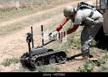 A soldier from the 666th Ordnance Company operates a bomb disposal ...