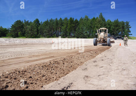 U.S. Soldiers, assigned  to 3rd Platoon, 500th Engineer Company, 15th Engineer Battalion, perform dig site operations with a 120M Motor Grader at the 7th Army Joint Multinational Training Command’s Grafenwoehr Training Area, Germany, July 1, 2015. The company prepares for a deployment to Estonia in support of Operation Atlantic Resolve. (U.S. Army photo by Visual Information Specialist Gertrud Zach/Released) 15th Engineer Battalion dig site operations in preparation for OAR 150701-A-HE359-023 Stock Photo