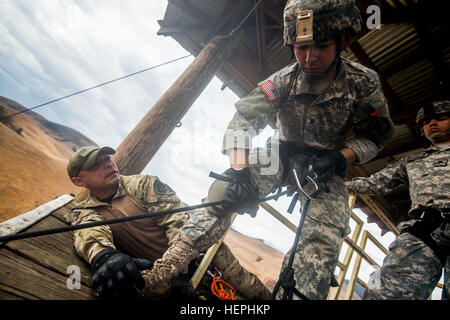 Soldier training rappel with rope. Military man does hanging on
