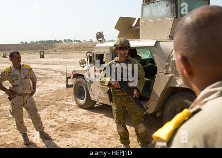 An Australian soldier assigned to Task Group Taji prepares to demonstrate the proper procedures for performing five and 25-meter checks during counter improvised explosive device training at Camp Taji, Iraq, Aug. 2, 2015. Training at the building partner capacity sites is an integral part of Combined Joint Task Force – Operation Inherent Resolve’s multinational effort to train Iraqi security force personnel to defeat the Islamic State of Iraq and the Levant. A coalition of nations have joined together to defeat ISIL and the threat they pose to Iraq, Syria, the region and the wider internationa Stock Photo